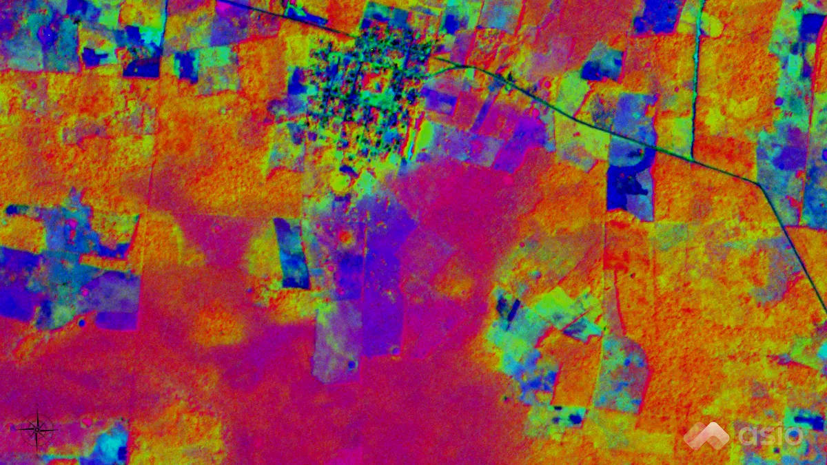 False-color composite of the first three principal components of the small sample scene: fields in orange and magenta, a town in green and blue, and a road crossing the upper right.
