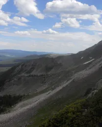 Trailriders Wall above the Quemado Basin under an afternoon sky.